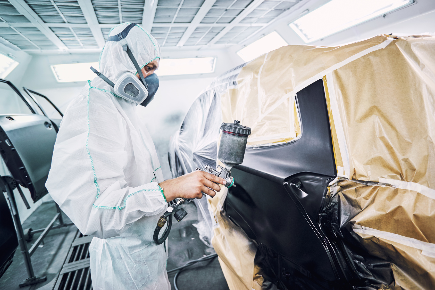 Restoration painting of a black car in the service center.